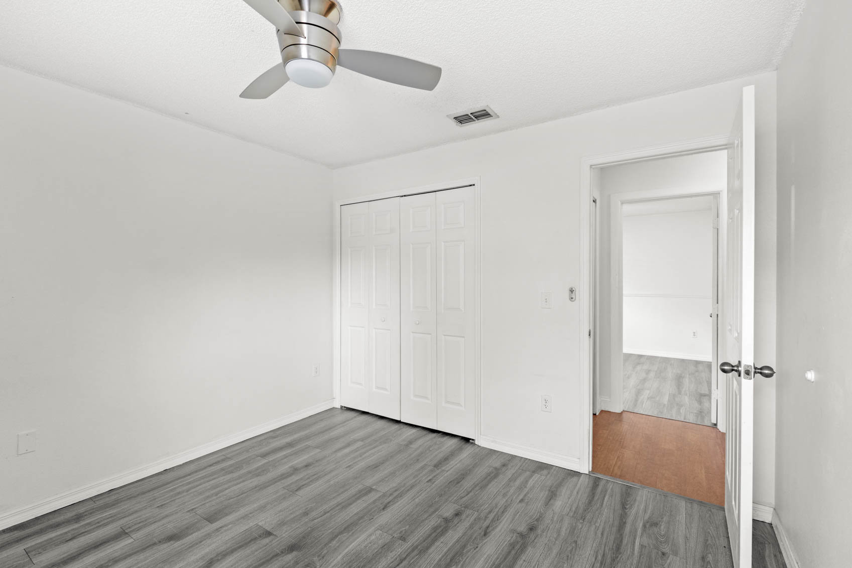 bedroom with grey wooden floors